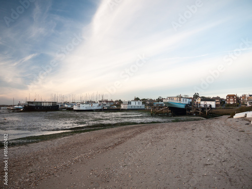 landscape sea front house row in distance beach