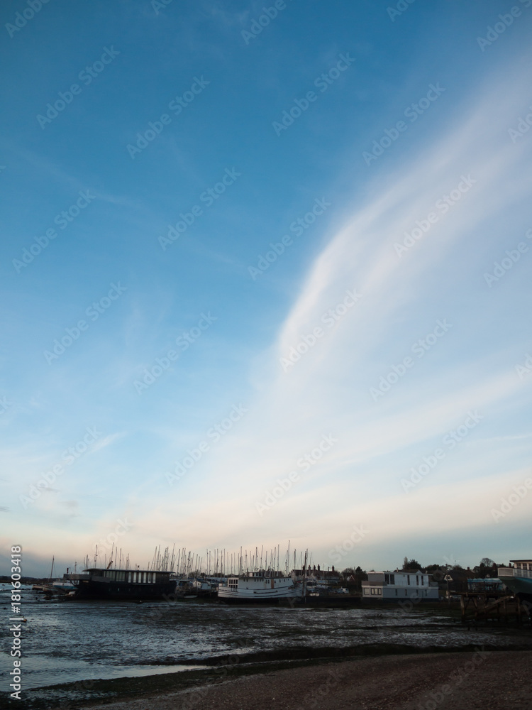 row of beach front marina houses with big open blue sky space