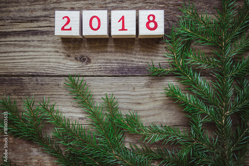 Christmas picture: New year 2018 is made up of cubes with fir-tree branches