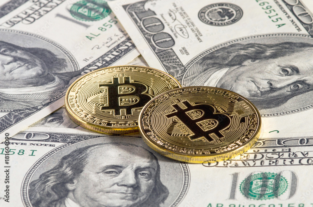 Golden bitcoin coin on us dollars close up. Golden bitcoin coin on us dollars close up.