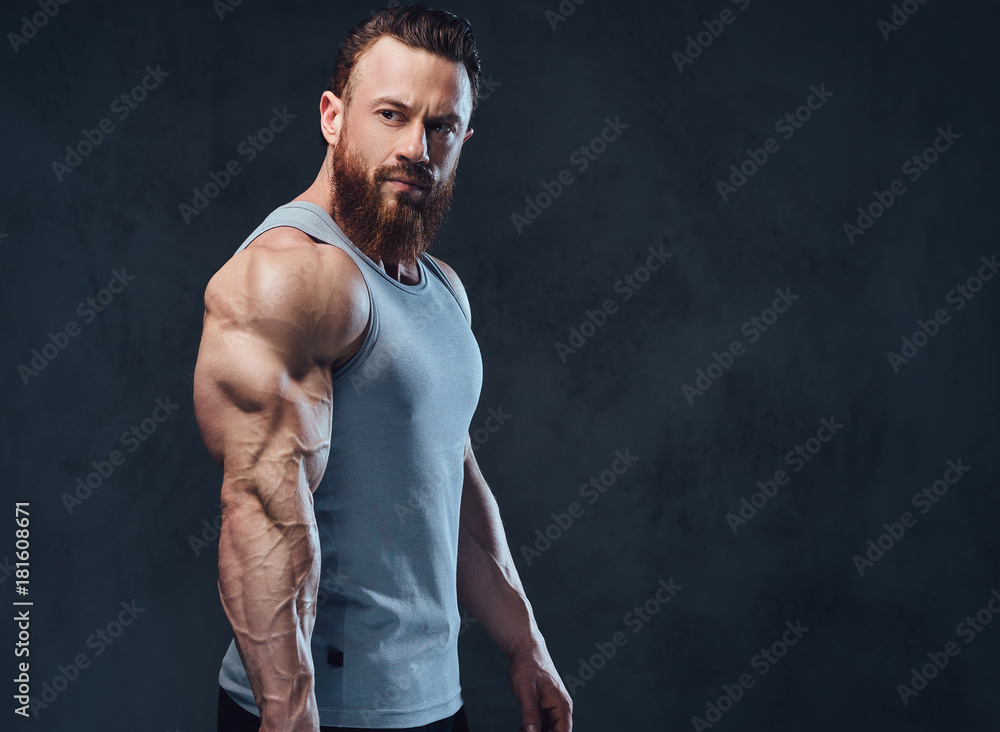 Bearded bodybuilder dressed in a tank top. Bearded bodybuilder dressed in a tank top.