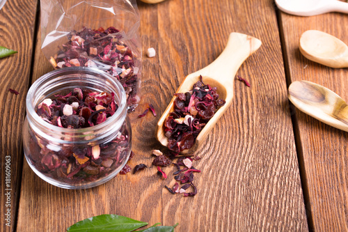 Fototapeta Naklejka Na Ścianę i Meble -  Herbal aroma fruit tea dry leaves on spoon on wooden background