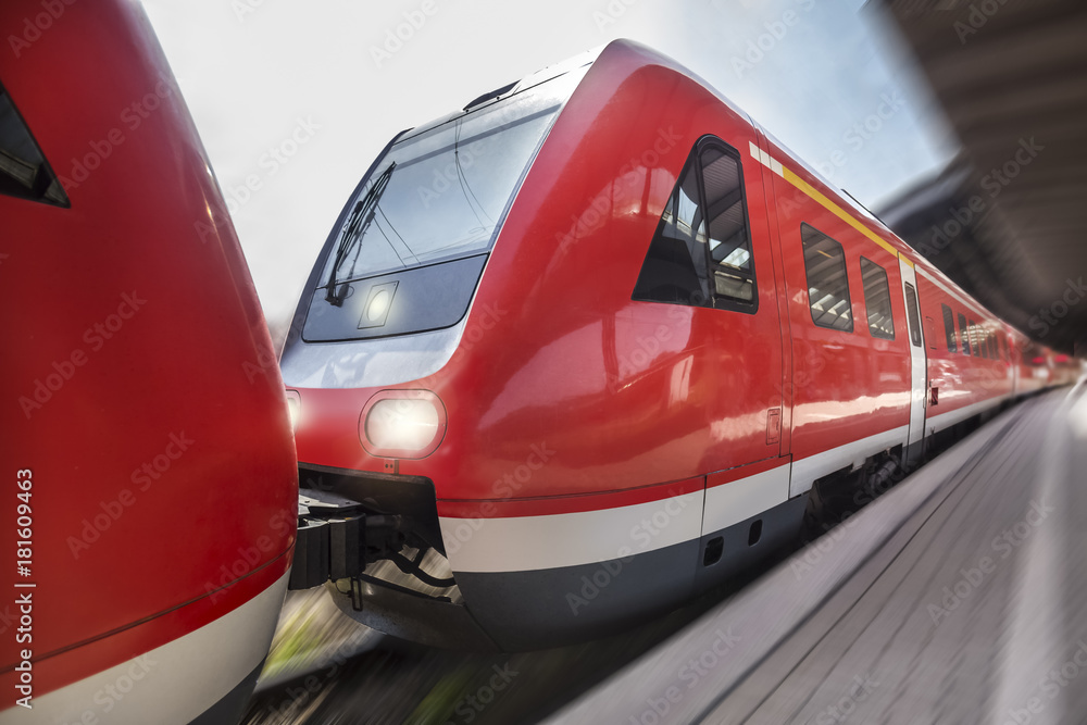 passenger train speeding through a train station