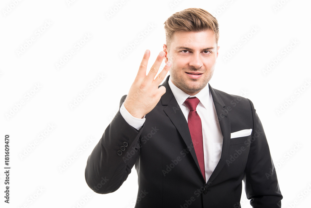 Portrait of handsome corporate business man showing number three Portrait of handsome corporate business man showing number three