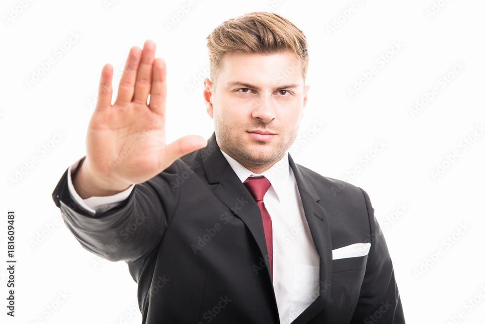 Portrait of handsome corporate business man showing stop gesture Portrait of handsome corporate business man showing stop gesture
