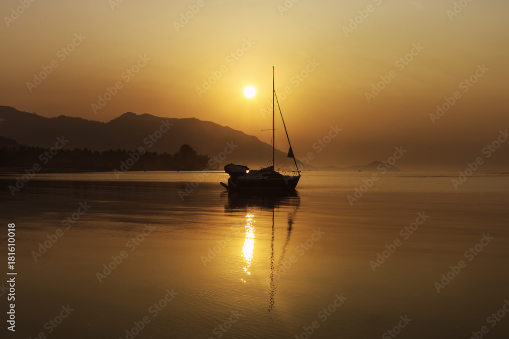 Sailing yacht at sunset on Koh Pha Ngan island, Thong Sala beach, Thailand