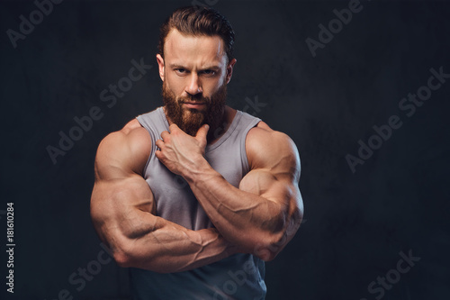 Bearded bodybuilder dressed in a tank top.