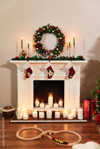 Christmas fireplace with Santa socks. Christmas stocking hanging from a mantel or fireplace, decorated for Christmas with fire glowing. New year design.