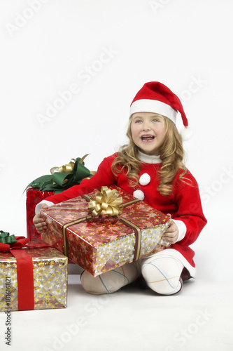 Little girl red dress santa hat with gift on white background