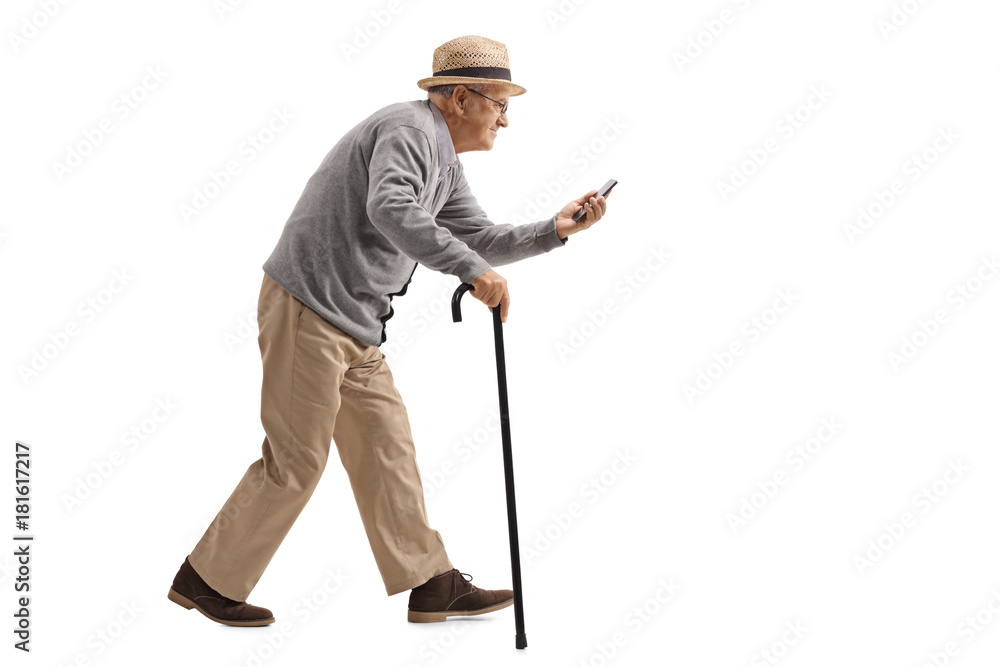 Senior with a cane walking and looking at a phone Senior with a cane walking and looking at a phone