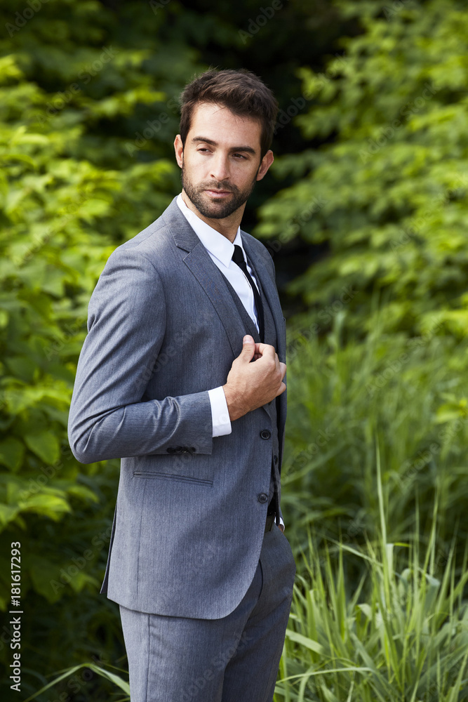 Businessman wearing smart, grey suit in thought Businessman wearing smart, grey suit in thought