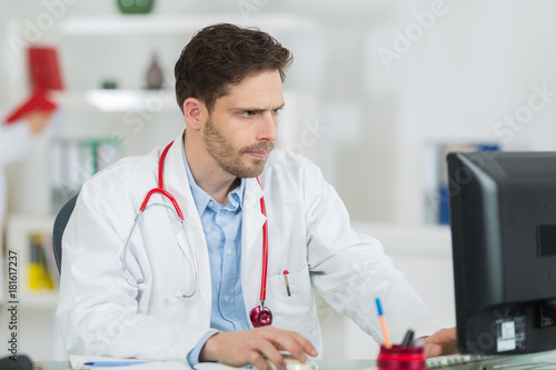 handsome male doctor working in office