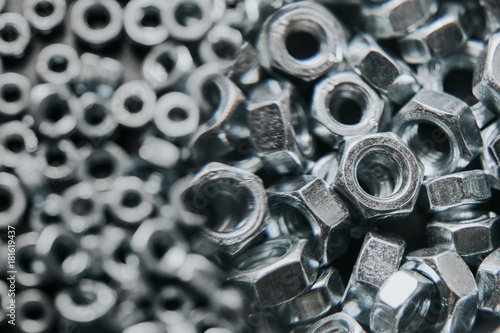 Metal shiny nuts enlarged with magnifying glass background. © Paweł Michałowski