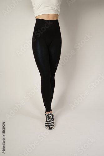 Woman's legs in a black sport pants. photo