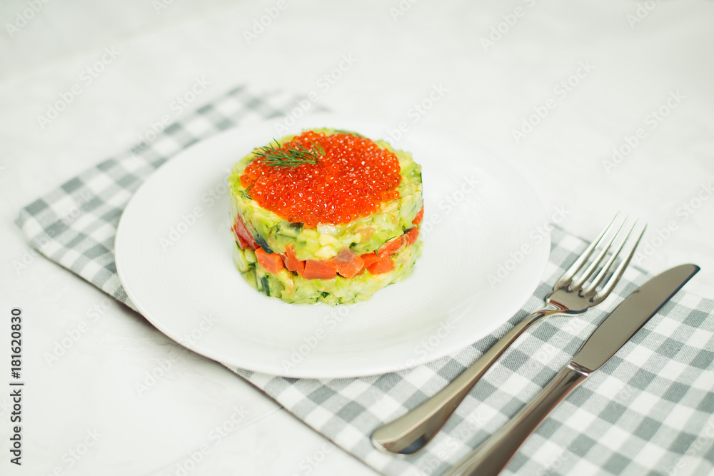 salad of salmon, avocado and red caviar