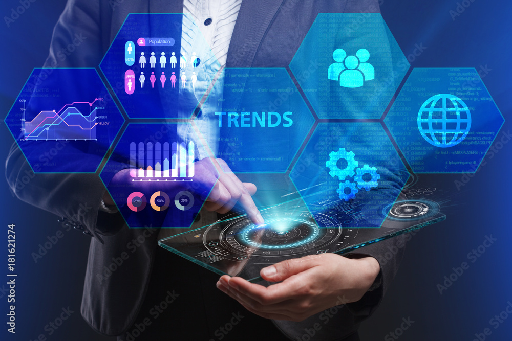 Fototapeta premium The concept of business, technology, the Internet and the network. A young entrepreneur working on a virtual screen of the future and sees the inscription: Trends