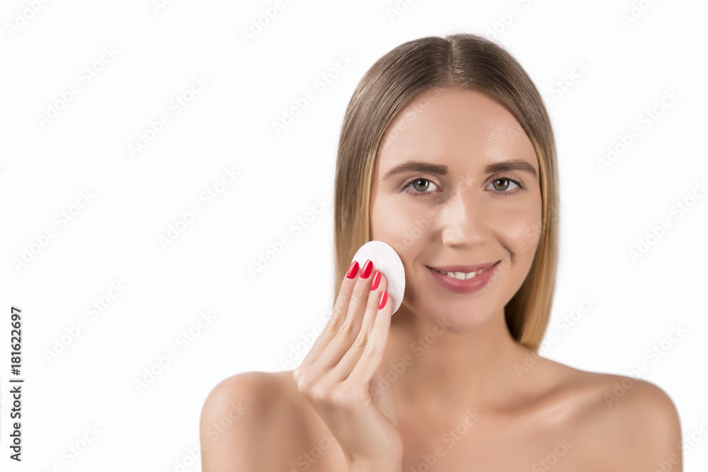 beauty, people and skincare concept - young woman cleaning face with exfoliating sponge beauty, people and skincare concept - young woman cleaning face with exfoliating sponge