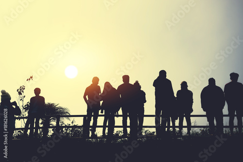 asians travel relax in the holiday.People stand looking at the sun in the morning. Stand up for sunrise on the Moutain