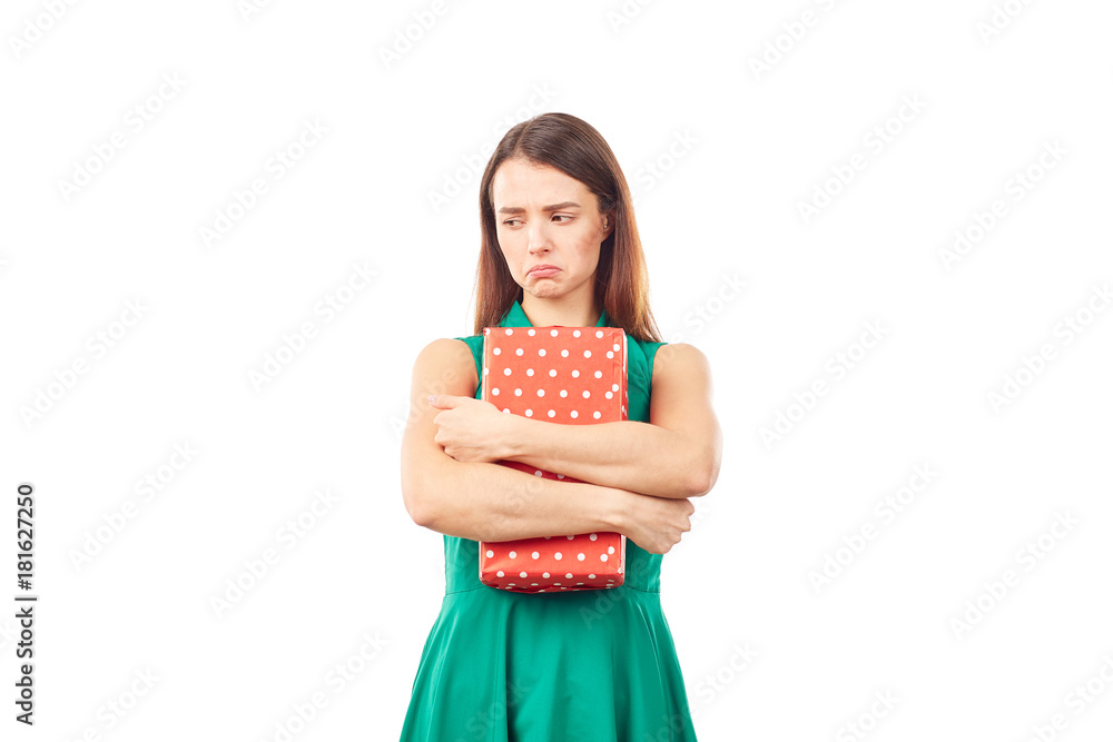 Portrait of young woman holding gift box wrapped in red paper Portrait of young woman holding gift box wrapped in red paper