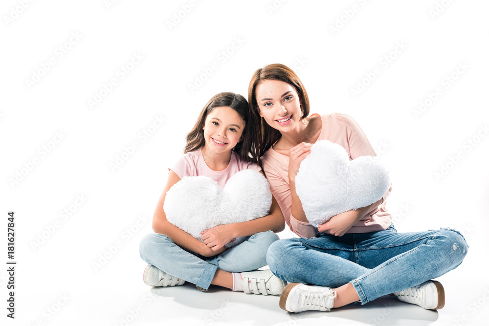 Daughter and mother with heart shaped pillows Daughter and mother with heart shaped pillows