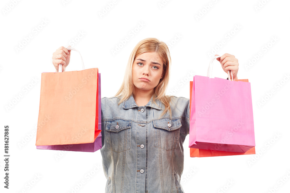 Portrait of young blonde woman holding shopping bags in both hands Portrait of young blonde woman holding shopping bags in both hands