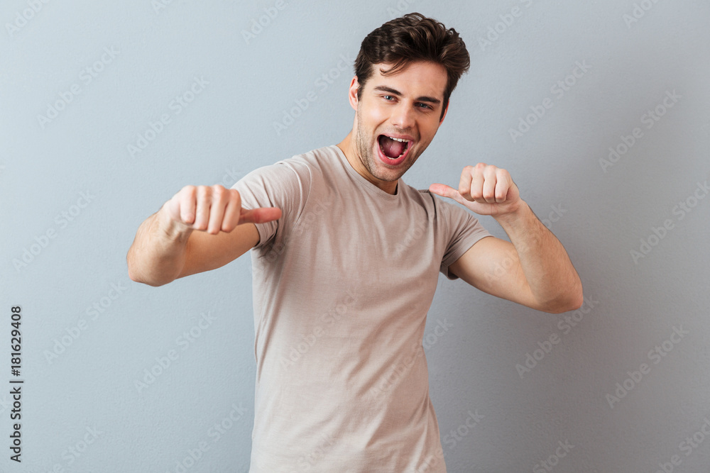 Portrait of a smiling excited man showing thumbs up gesture Portrait of a smiling excited man showing thumbs up gesture