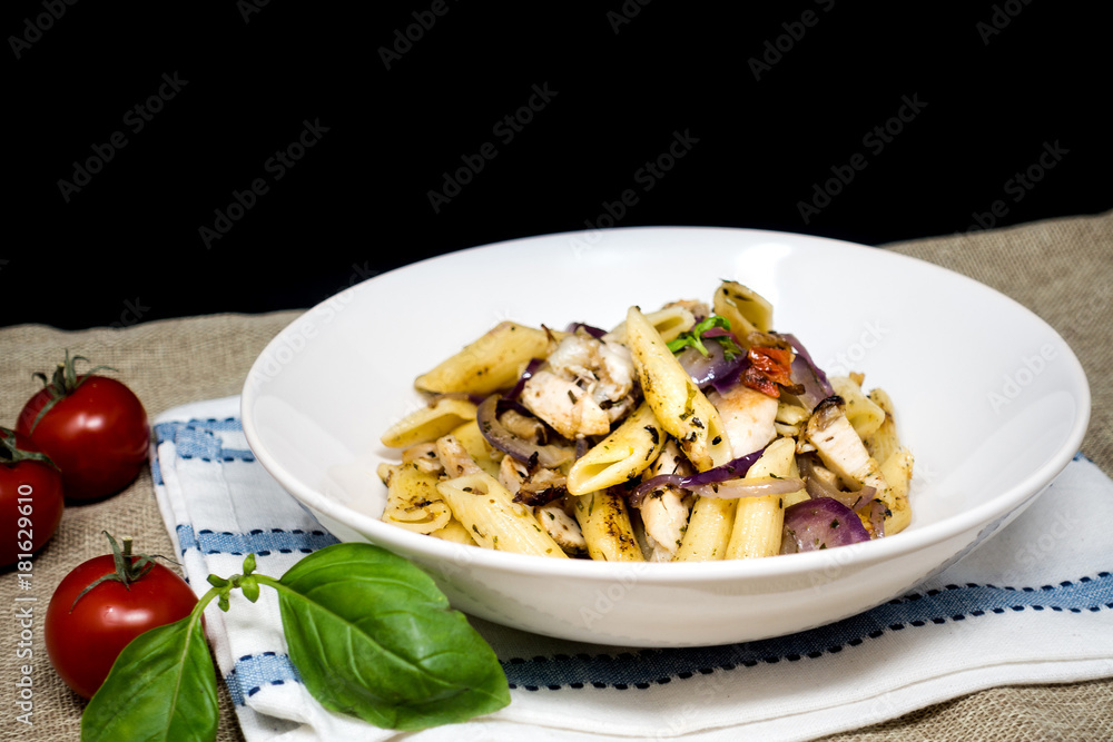 Pasta with pesto sauce and nuts on a the table