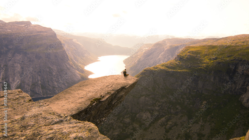 Sitting on the edge of Trolltunga in Norway.