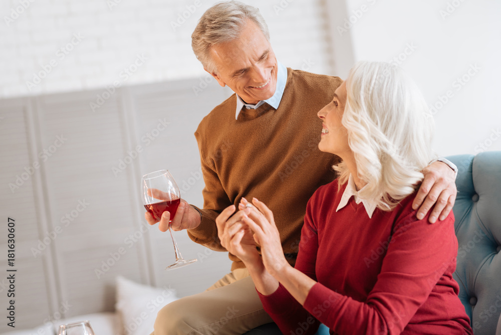 Newly engaged. Selective focus on a retired man looking at his fiancee while both enjoying a pleasant conversation and celebrating their engagement. Newly engaged. Selective focus on a retired man looking at his fiancee while both enjoying a pleasant conversation and celebrating their engagement.