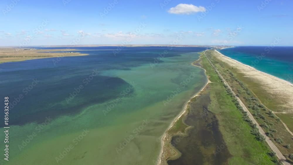 AERIAL: Salty land between the sea and salt lakes / Flying over salt lake and blue sea, aerial video, video shooting with drone AERIAL: Salty land between the sea and salt lakes / Flying over salt lake and blue sea, aerial video, video shooting with drone