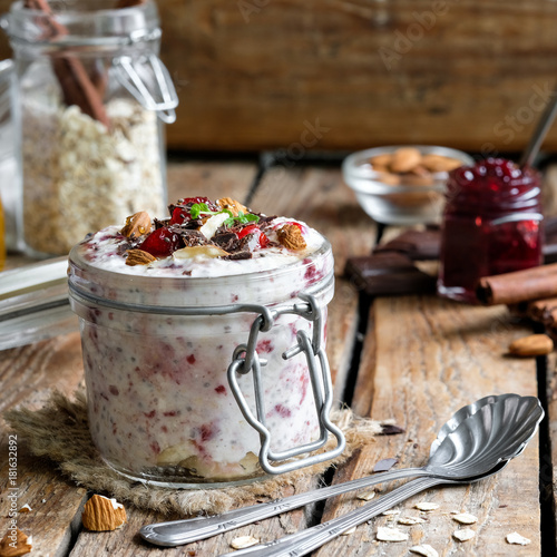 Obraz na plátne overnight oatmeal in a jar with cherry jam and chocolate