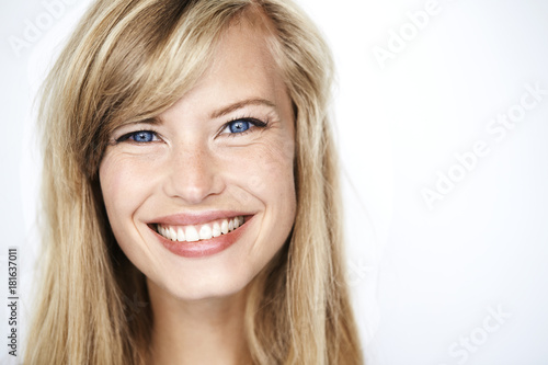 Bright eyed blond woman smiling to camera, portrait