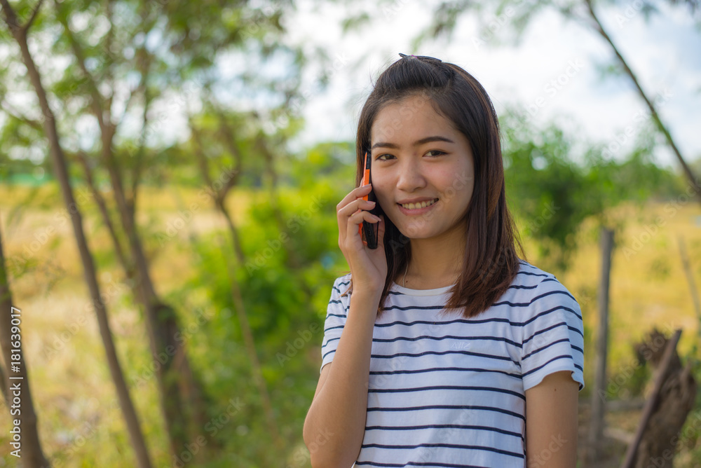 Portrait of asian girl talking on telephone Portrait of asian girl talking on telephone