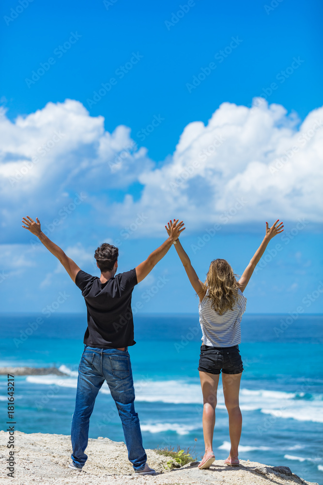 Couple enjoying with arms wide open at the sea / ocean. Couple enjoying with arms wide open at the sea / ocean.