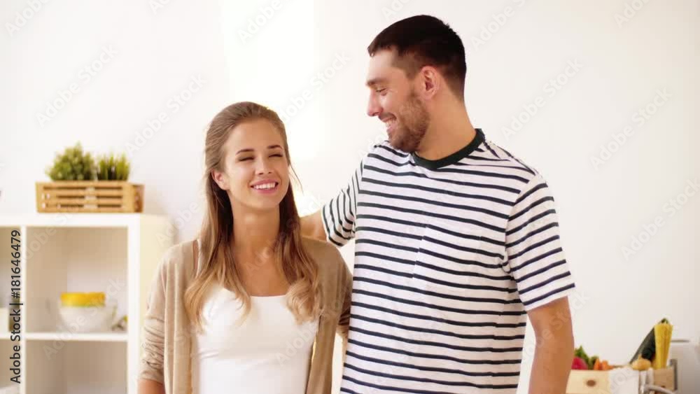 happy couple hugging at home kitchen happy couple hugging at home kitchen