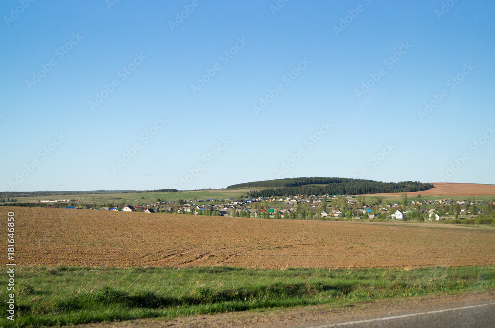Russian town on field with blue sky