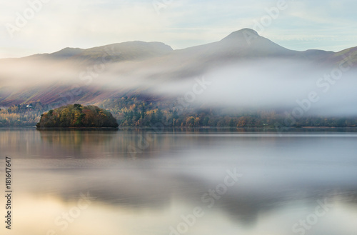 Mist rolling past mountains at Derwentwater in the English Lake District on an Autumn morning.