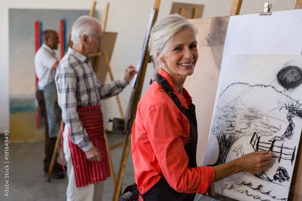 Portrait of woman drawing on paper while standing by friends Portrait of woman drawing on paper while standing by friends