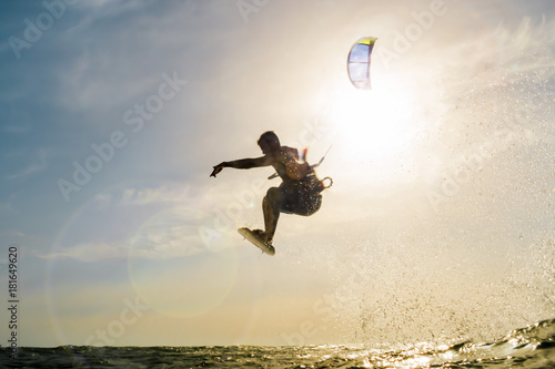 Surfer flying in front of the sunset