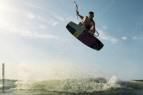 Surfer jumping in front of the camera