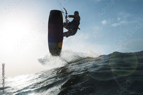 Surfer jumping a wave in front of the camera