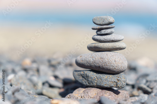 Close-up of stack of stones in perfect balance on a tranquil sunny beach in Fuerteventura, SpainClose-up of stack of stones in perfect balance on a tranquil sunny beach in Fuerteventura, Spain