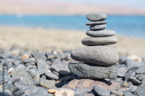 Close-up of stack of stones in perfect balance on a tranquil sunny beach in Fuerteventura, SpainClose-up of stack of stones in perfect balance on a tranquil sunny beach in Fuerteventura, Spain