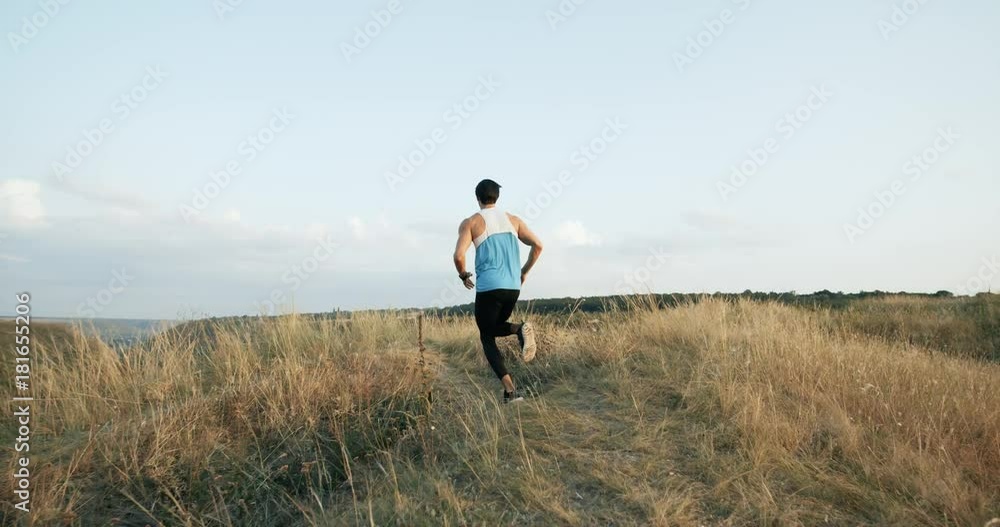 mountain landscape. European running man Jogging in the morning slow motion mountain landscape. European running man Jogging in the morning slow motion