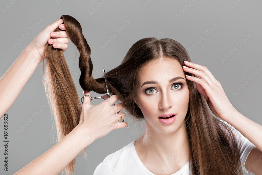 Naklejka premium woman with long hair holds scissors 