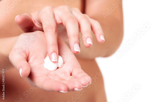 Closeup shot of beautiful woman s hands with cream  isolated on white background