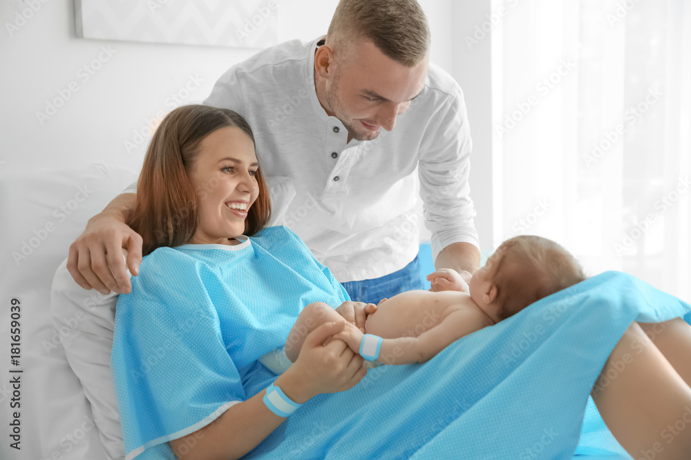 Happy young family with cute baby at hospital Happy young family with cute baby at hospital