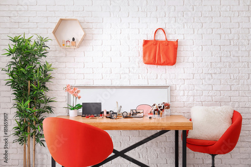 Set of decorative cosmetics and beauty accessories on dressing table indoors photo