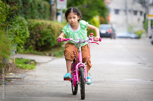 Fototapeta Naklejka Na Ścianę i Meble -  Soft focus happy children riding on bicycle