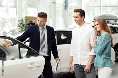 Young couple buying car in ...